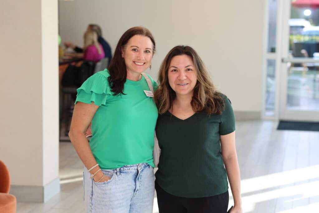 Crystal Davidson & Brenda Monjars at the Impact100 of Northwest Florida 2026 Member and Grant Number Reveal in Fort Walton Beach, Florida.