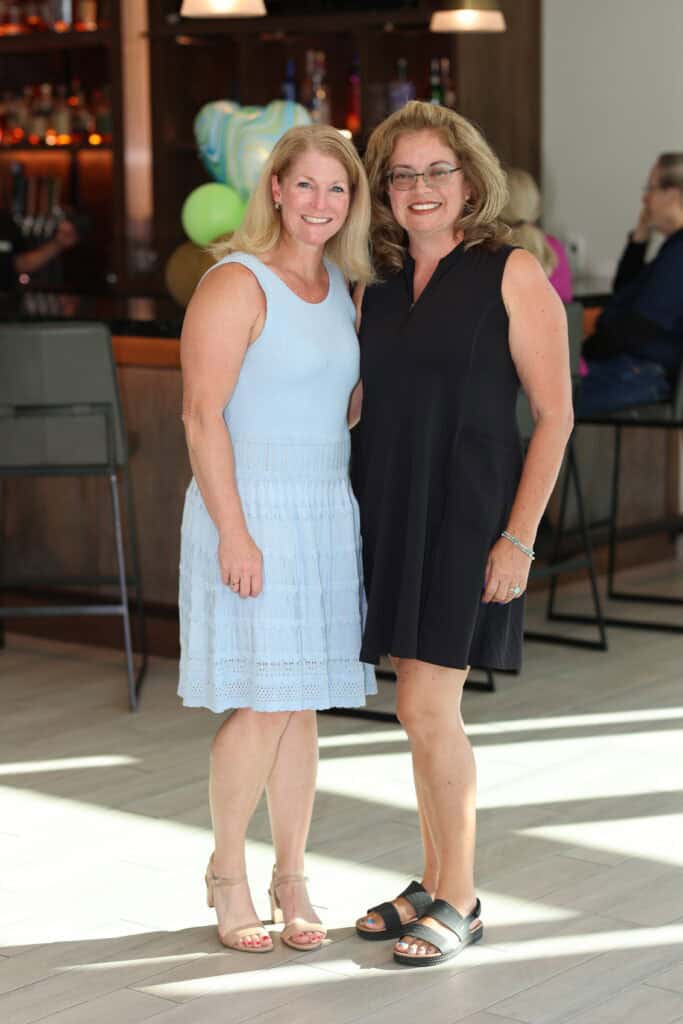 Elizabeth Burkhart & Angela Hassell at the Impact100 of Northwest Florida 2026 Member and Grant Number Reveal in Fort Walton Beach, Florida.